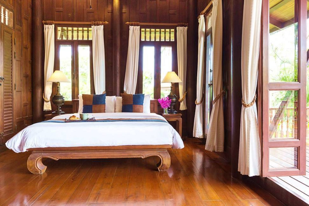 Wood-panelled bedroom with a platform bed at Villa Arun