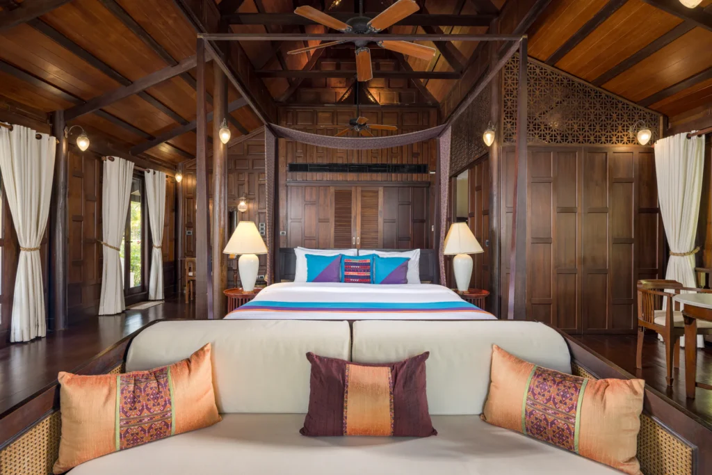 Bedroom with a canopy bed and Thai cushions at Villa Arun