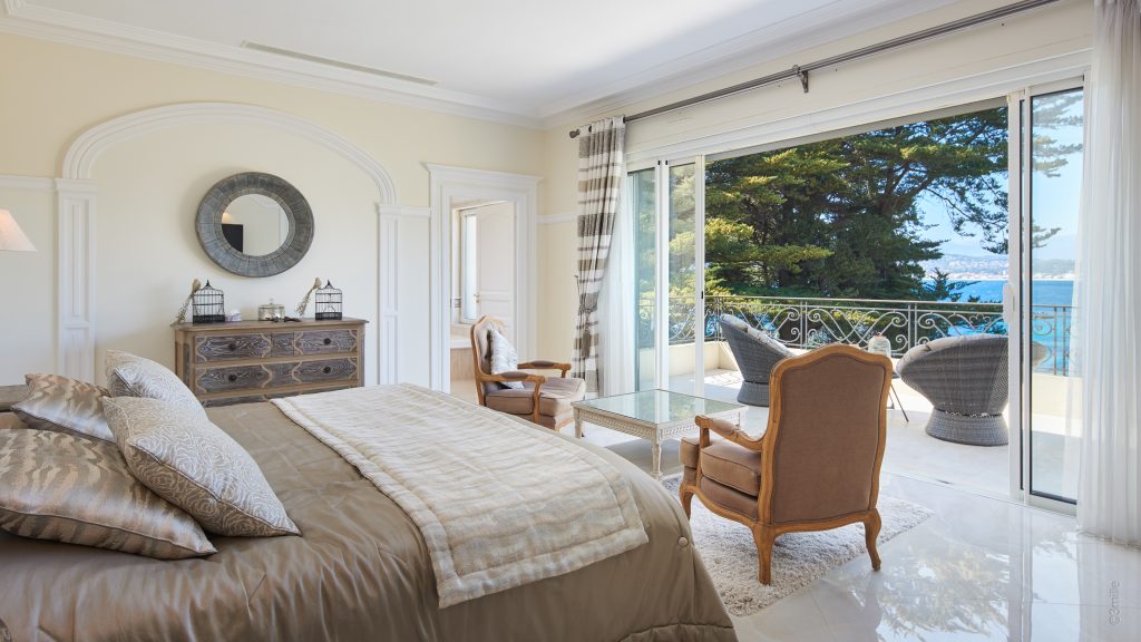 Bedroom opening onto the sea-view terrace at Villa Mareclaire