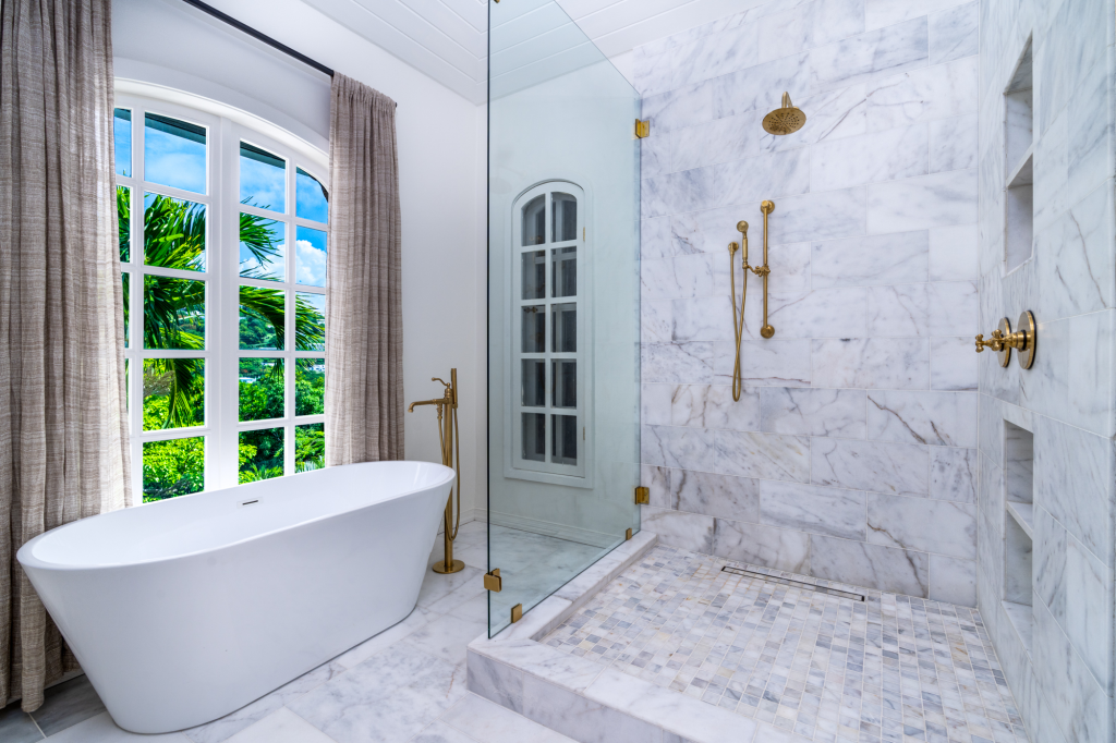 Bathroom with a freestanding bath and marble shower at Bellevue Tennis Estate