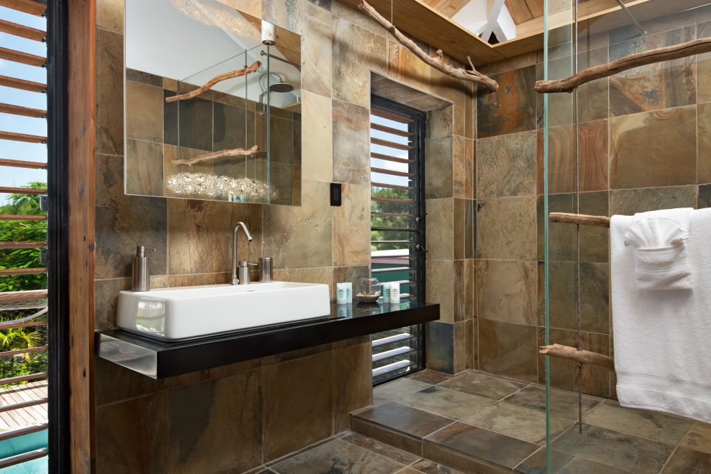 Bathroom with a stone-clad shower at Silver Sands Padel Villa