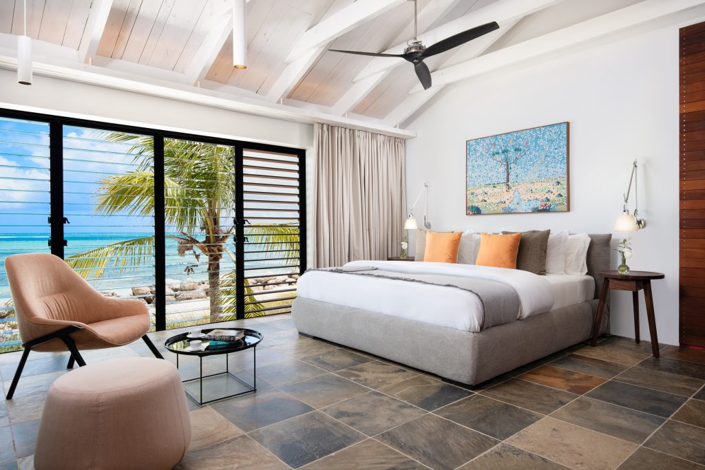 Bedroom with a king bed and sea views at Silver Sands Padel Villa