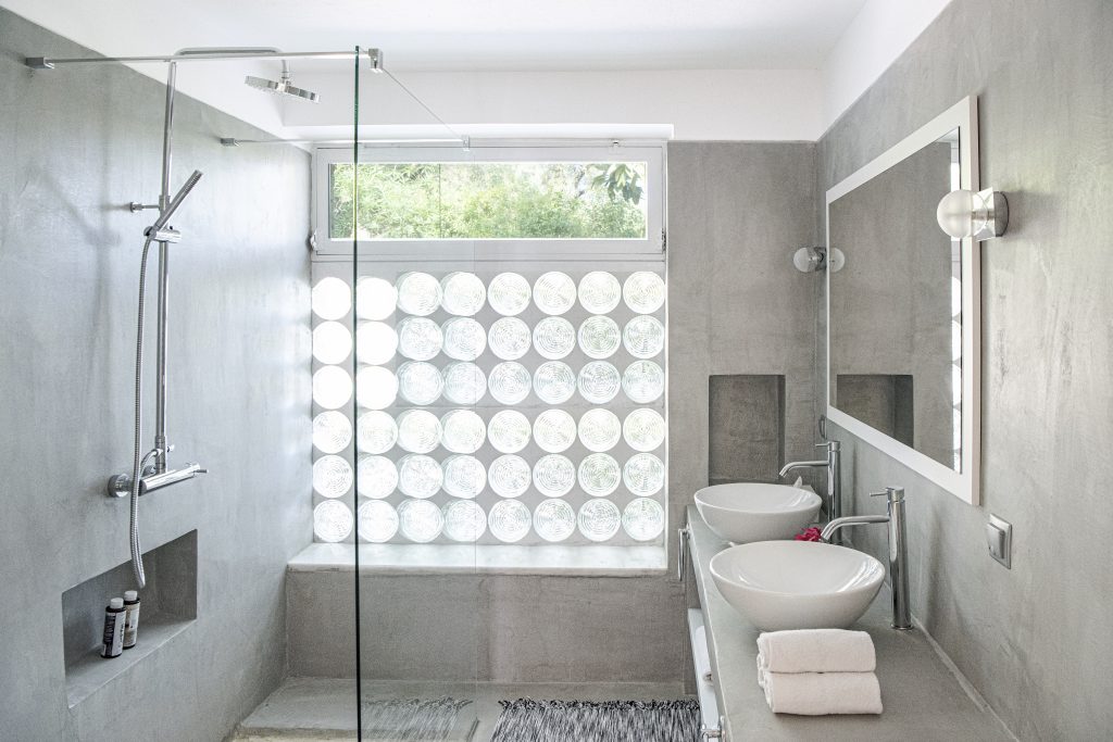 Bathroom with a double vanity and walk-in shower at Kastalia Estate