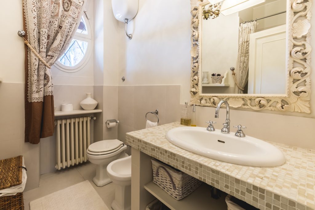 Bathroom with a stone vanity and mirrors at Tenuta 4 Pini