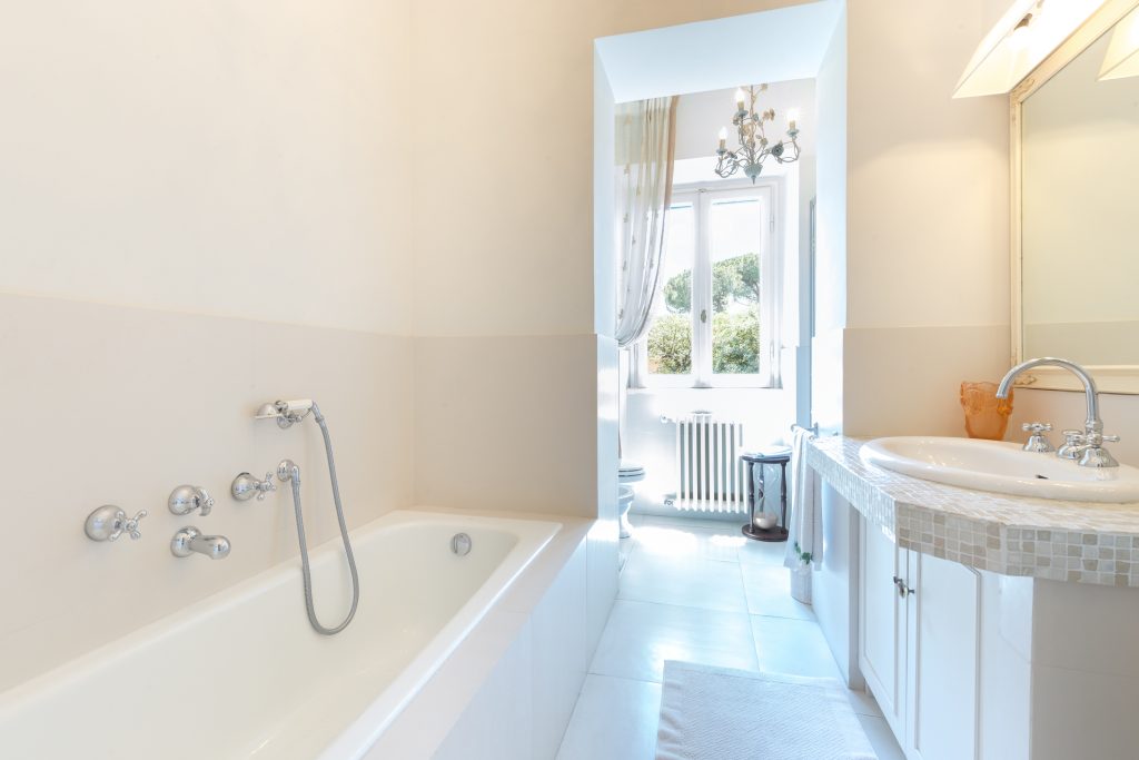 Bathroom with a bathtub and window at Tenuta 4 Pini