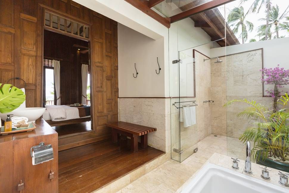 Bathroom with a walk-in shower and wooden details at Villa Arun