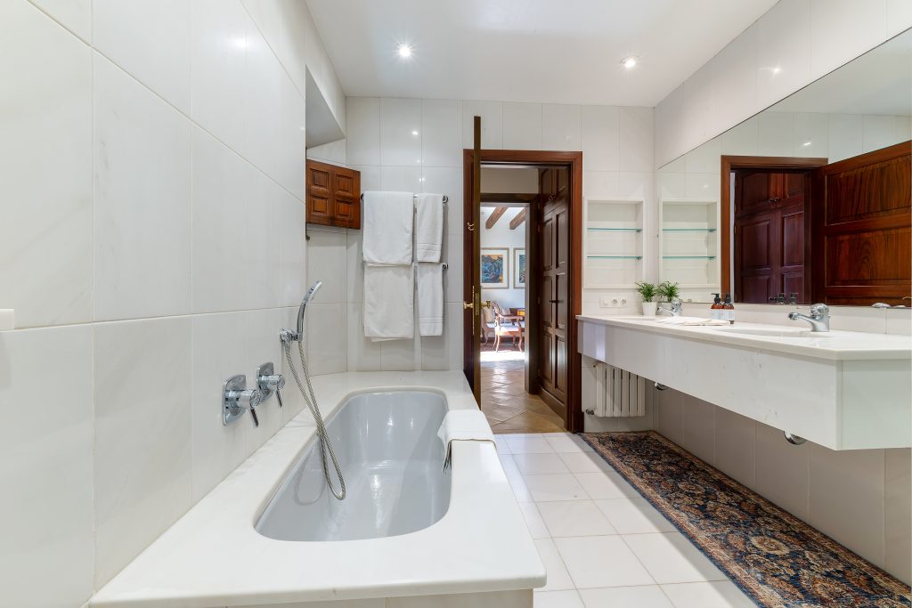 Bathroom with a freestanding bath and long vanity at Villa Solana