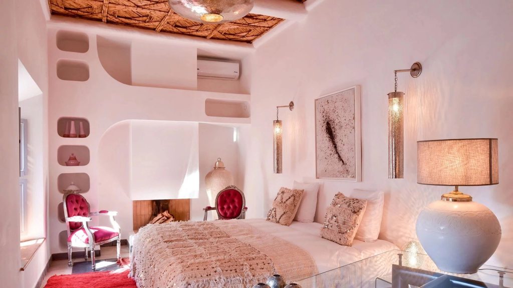 Bedroom with a sculpted fireplace niche at Domaine Orielle