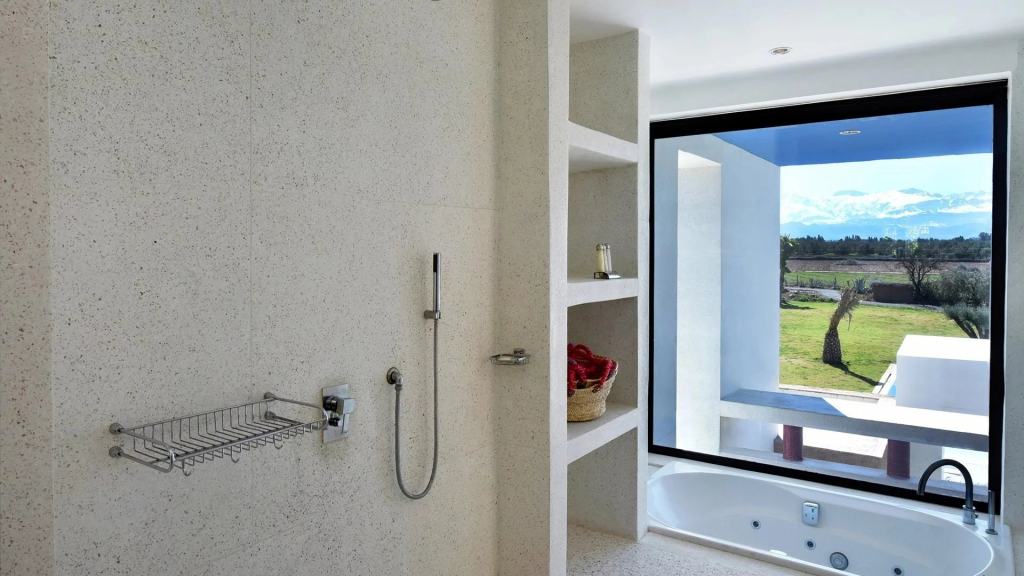 Bathroom shower with a window onto the garden at Domaine Orielle