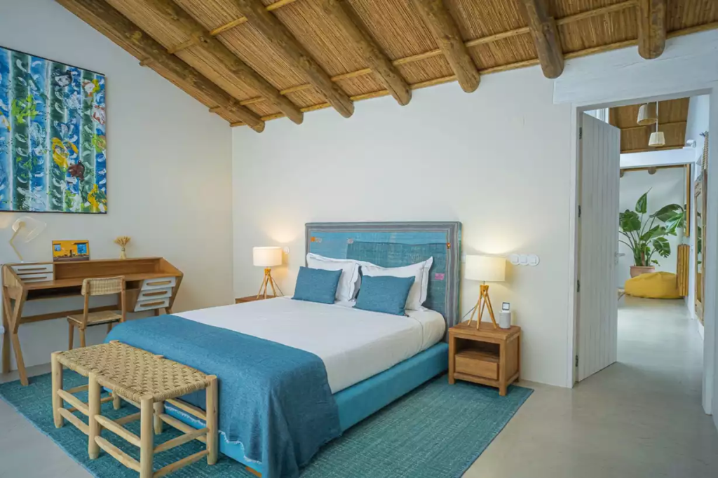 Bedroom with blue bedding at The Alba Estate