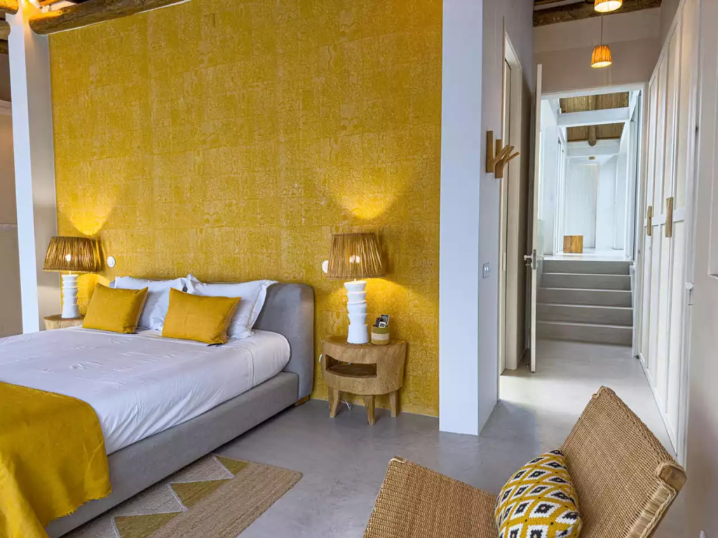 Bedroom with yellow walls at The Alba Estate