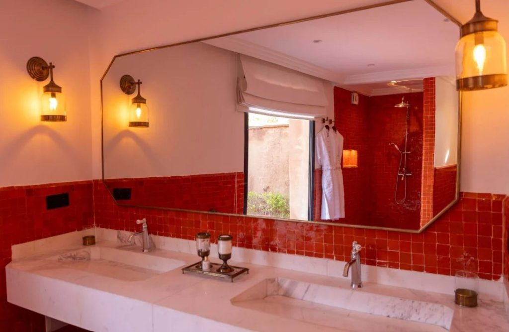 Bathroom in warm red tones at Villa Nara