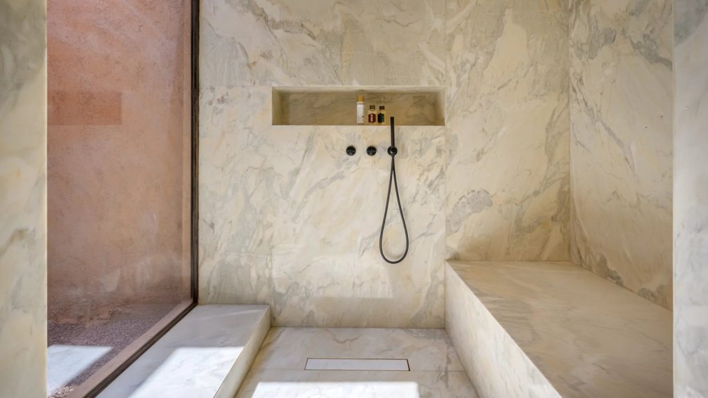Marble shower with a recessed shelf at Villa Palmeraie