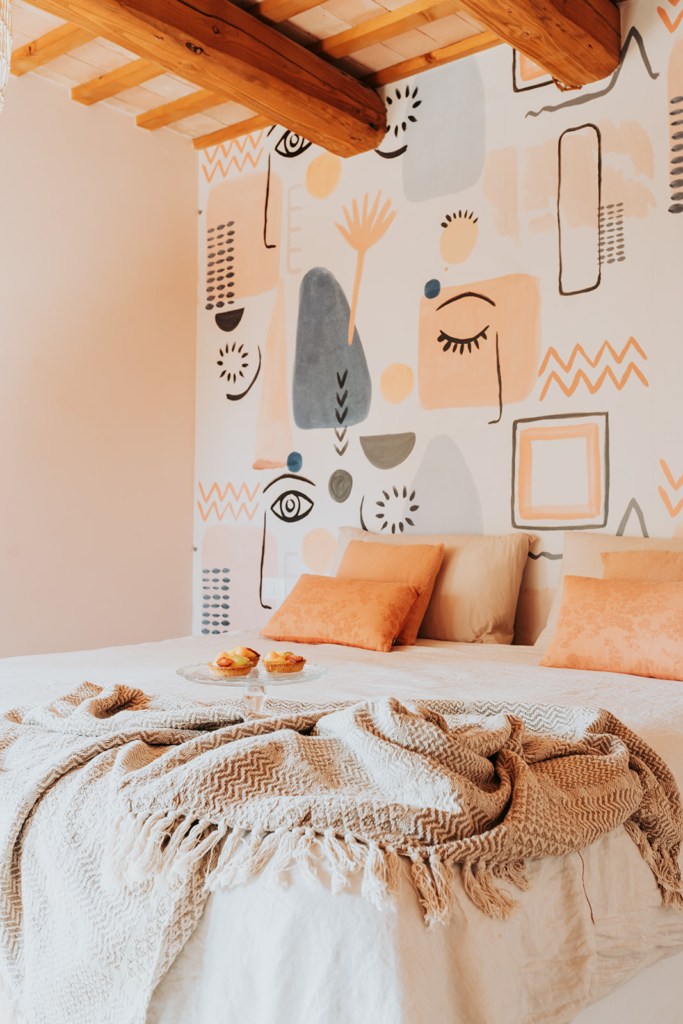 Bedroom with a double bed and peach accents at Tenuta Cassiana