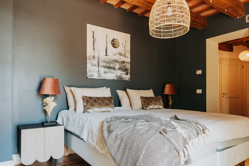 Bedroom with a double bed and woven pendant lights at Tenuta Cassiana
