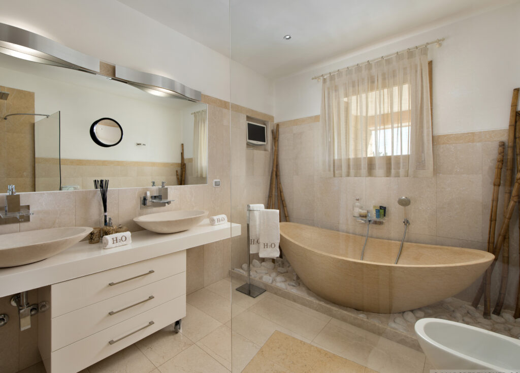 Bathroom with a freestanding bath and double vanity at Villa H2O
