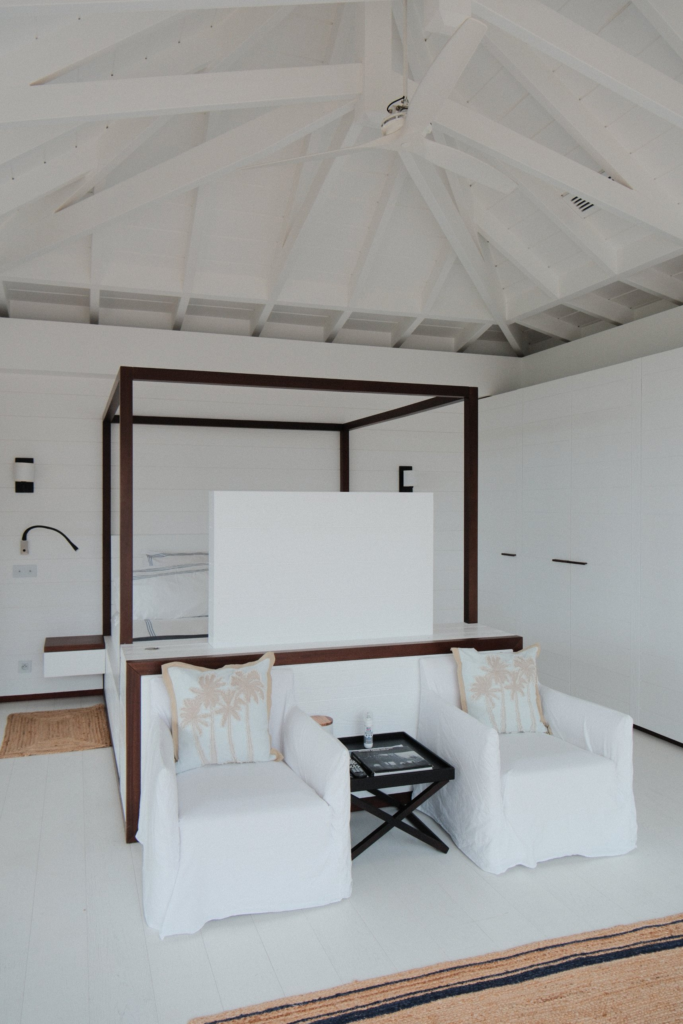 Villa Blanc Bleu bedroom with canopy bed and white armchairs