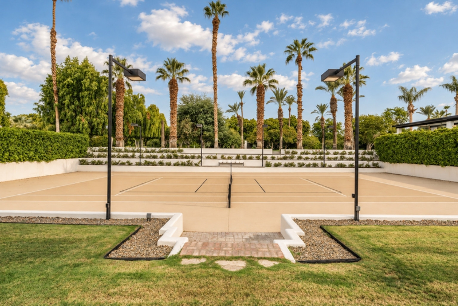 Steps from the garden down to the sunken tennis court at Domus Atticus Estate, Rancho Mirage