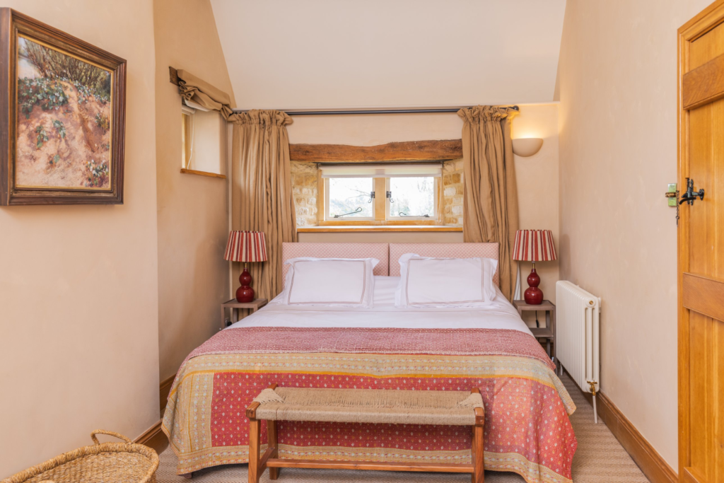 Bedroom with red and pink kantha quilt